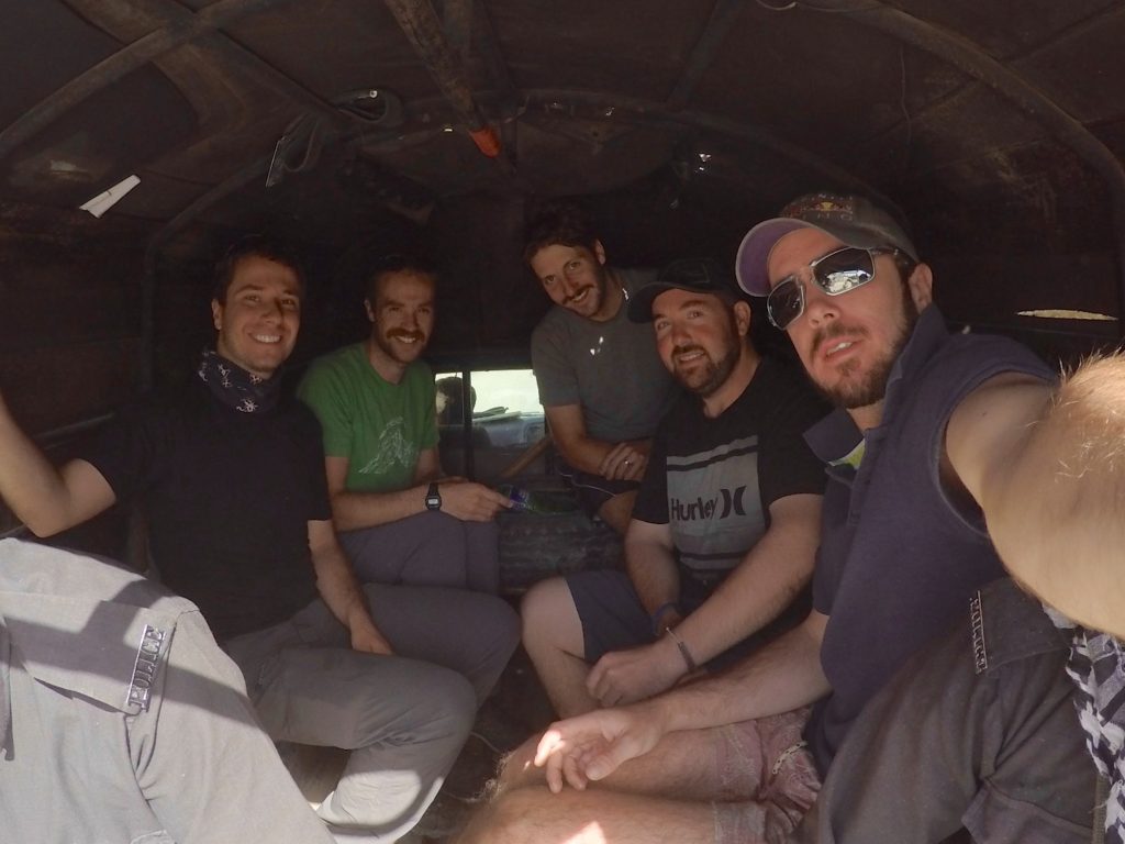 Riding in the back of a police ute in Quetta with some fellow overlanders to get our government permission to proceed on our journey